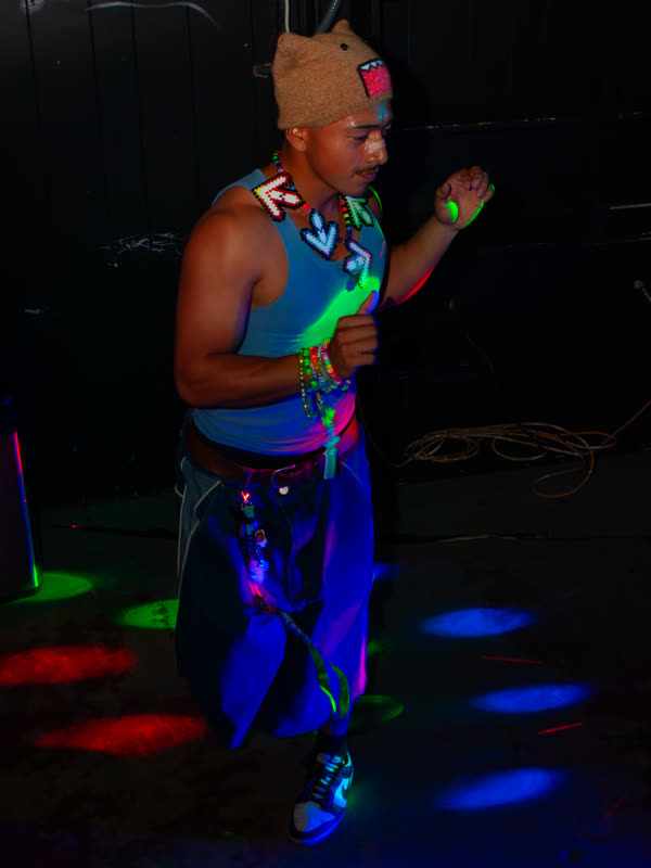 Guest dancing in a turquoise top at Dress to Impress, photographed by Jay Snaps