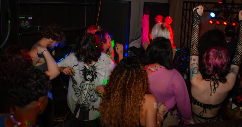 Crowd gathered on the dance floor at Dress to Impress, photographed by Jay Snaps