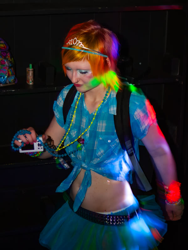 Guest dancing in a blue and green outfit at Dress to Impress, photographed by Jay Snaps