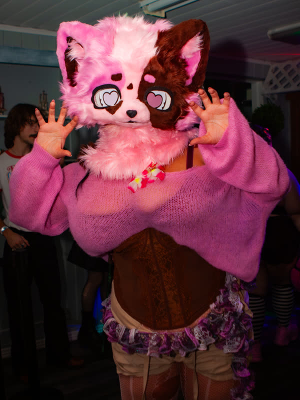 Guest posing in a pink animal mask at Dress to Impress, photographed by Jay Snaps