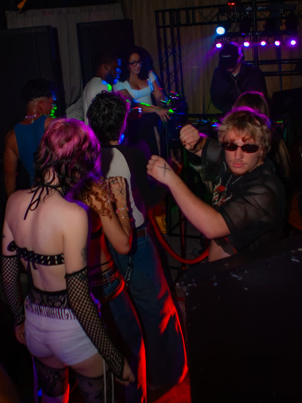 Friends dancing together at Dress to Impress, photographed by Jay Snaps