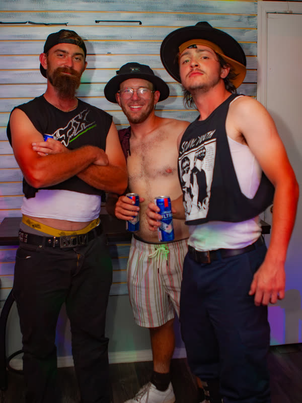 Three friends posing together at Dress to Impress, photographed by Jay Snaps