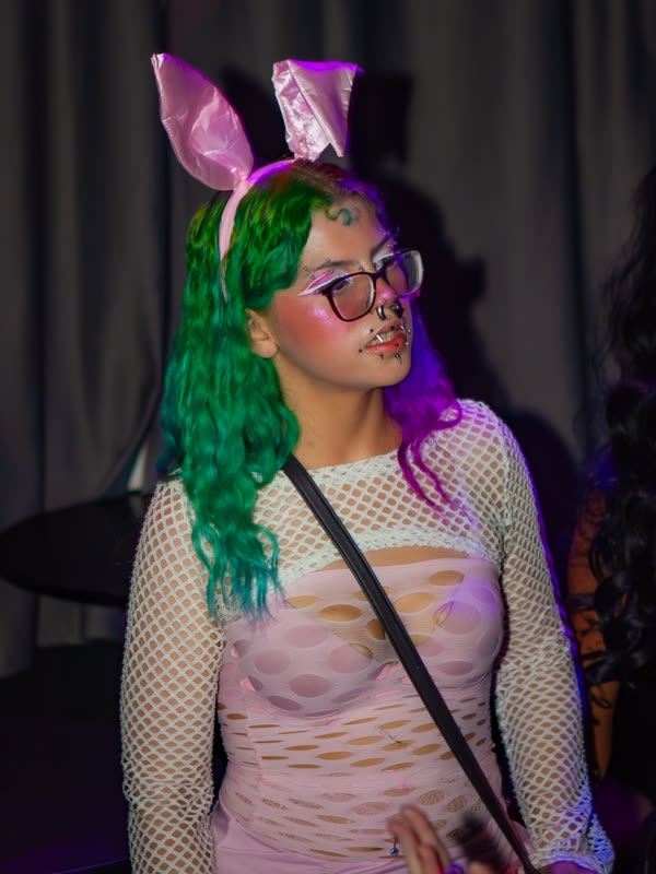 Guest wearing bunny ears and a green wig at Dress to Impress, photographed by Jay Snaps