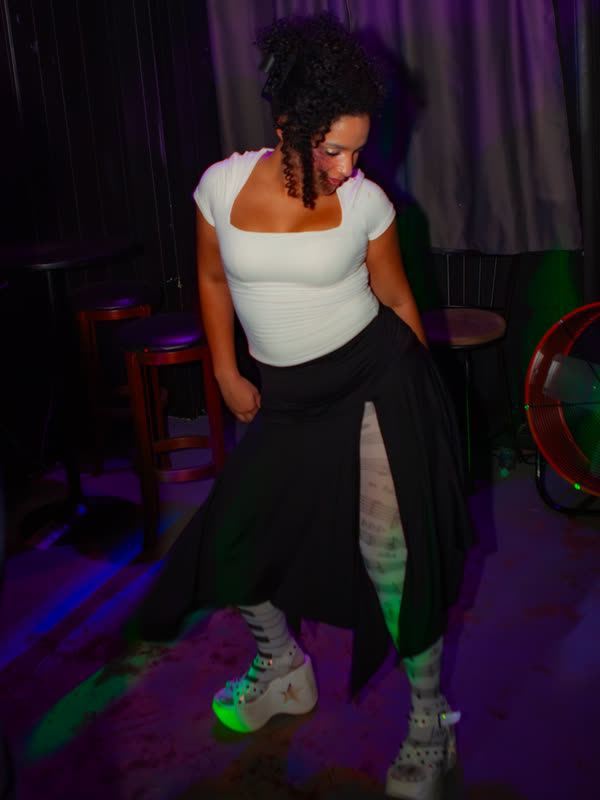 Guest dancing in a white top and black skirt at Dress to Impress, photographed by Jay Snaps